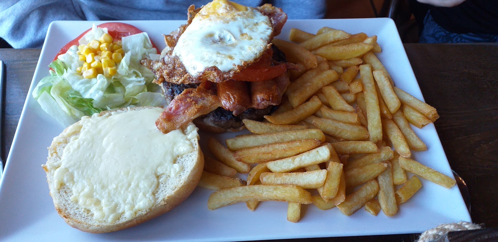 Burger with a fried egg and fries