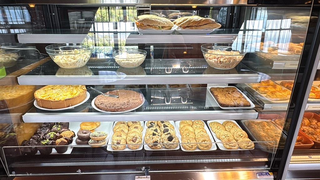 Chilled display of sandwiches, salads, cakes and cookies