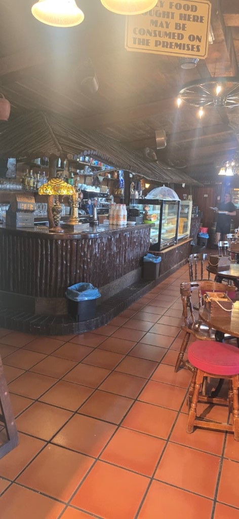 Log cabin bar counter with Tiffany lamp and food display