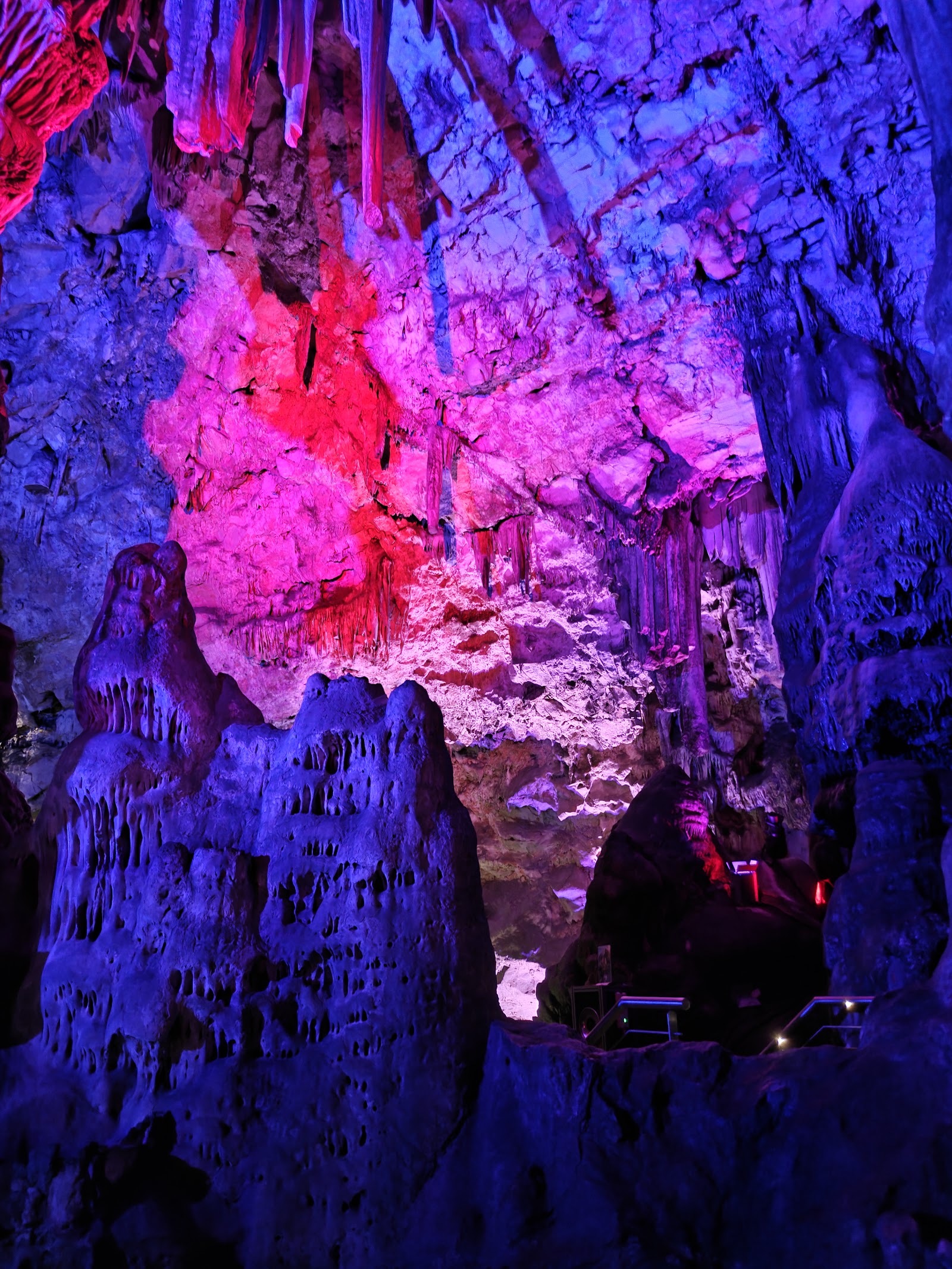 Inside St Michael's Cave, lit in pink and blue